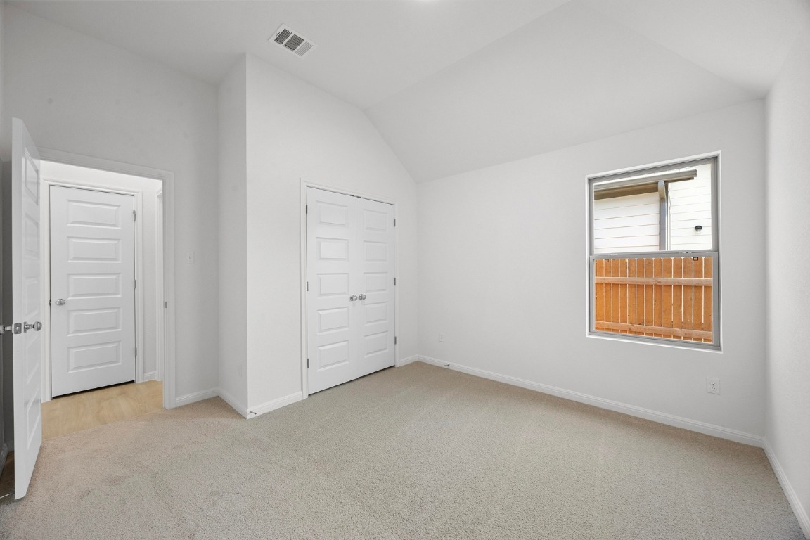 437 Lucky Avenue Elgin, TX 78621 - Photo 24 of 35 an empty room with windows and closet