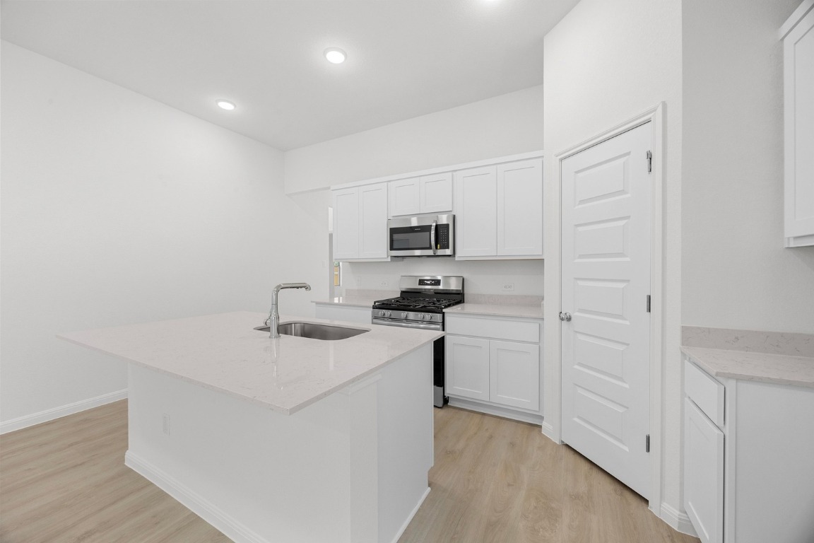 437 Lucky Avenue Elgin, TX 78621 - Photo 3 of 35 a kitchen with cabinets and appliances