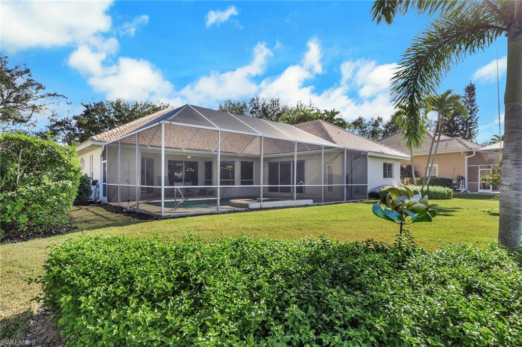 11079 Phoenix Way Naples, FL 34119 - Photo 12 of 30 Rear view of house with glass enclosure, a pool, a lawn, and a sunroom