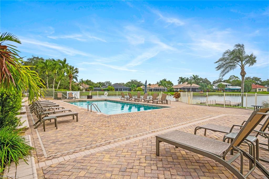 11079 Phoenix Way Naples, FL 34119 - Photo 23 of 30 Community pool with a patio area