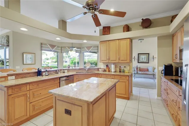 a kitchen with granite countertop a sink counter top space appliances and cabinets