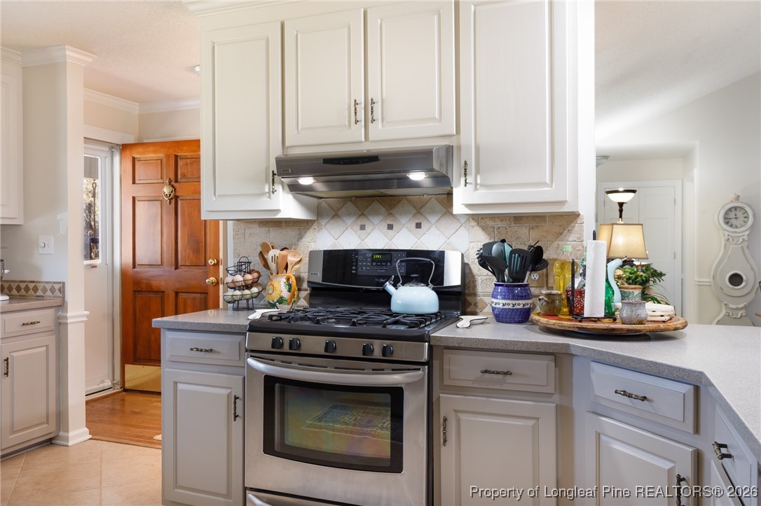 2574 Norrington Road Lillington, NC 27546 - Photo 11 of 50 a kitchen with stainless steel appliances granite countertop white cabinets and a stove