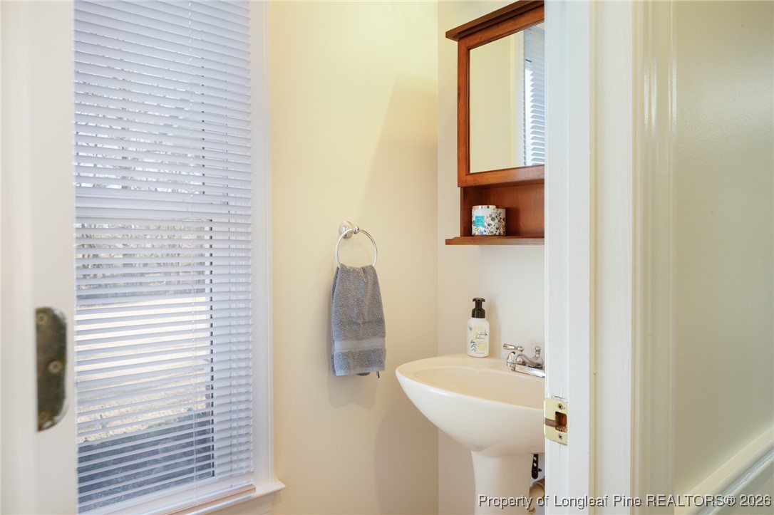 2574 Norrington Road Lillington, NC 27546 - Photo 18 of 50 a bathroom with a sink and a mirror
