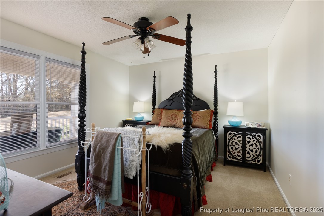 2574 Norrington Road Lillington, NC 27546 - Photo 22 of 50 a bed room with a bed window and furniture