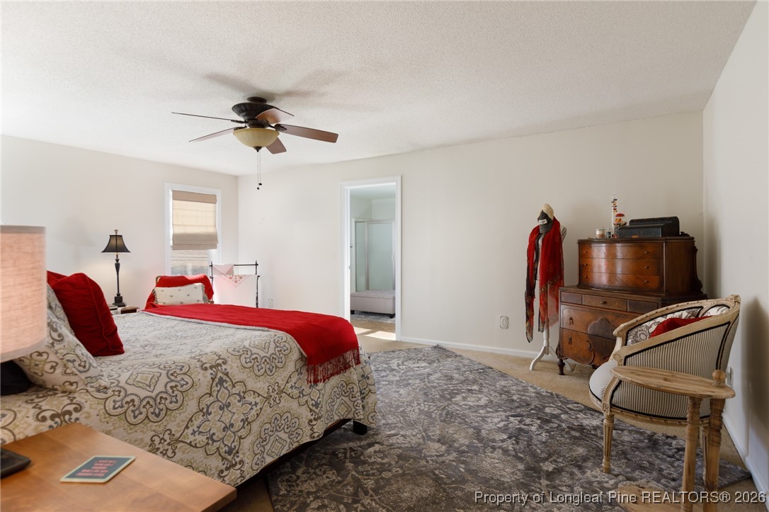 2574 Norrington Road Lillington, NC 27546 - Photo 23 of 50 a bedroom with a bed and a chair