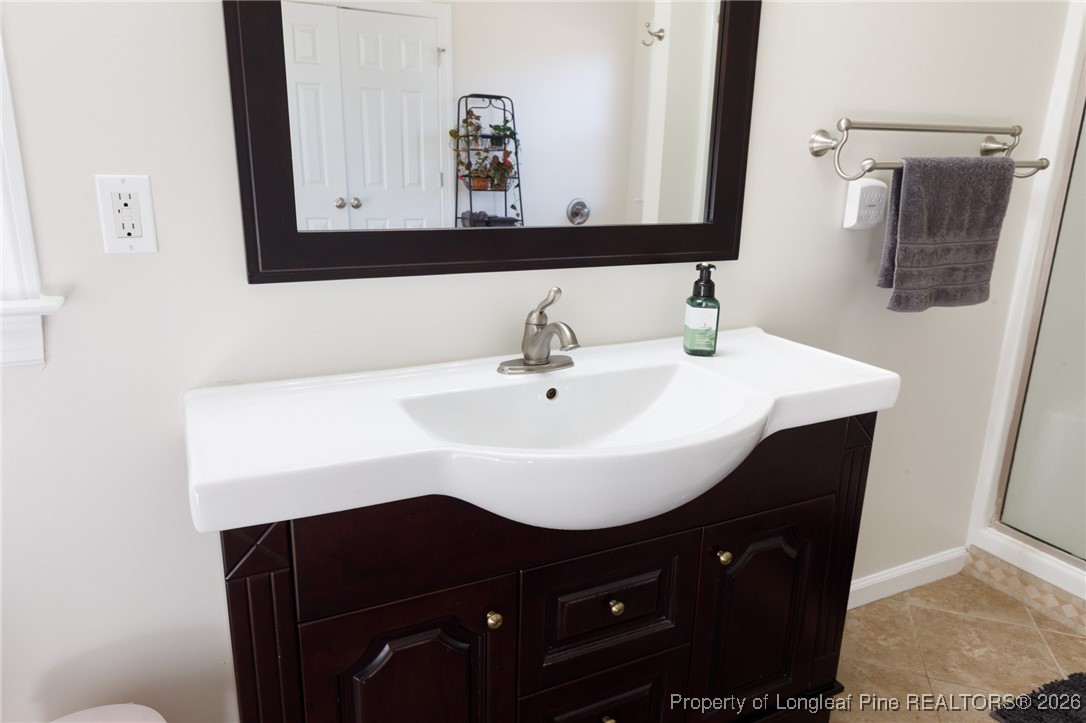2574 Norrington Road Lillington, NC 27546 - Photo 26 of 50 a bathroom with a sink and a mirror