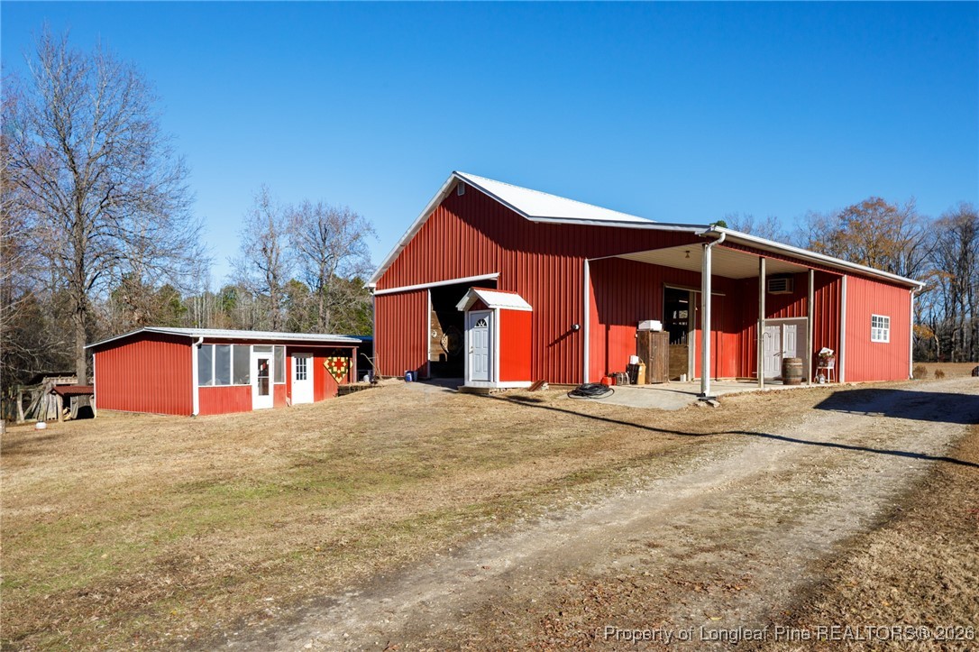 2574 Norrington Road Lillington, NC 27546 - Photo 36 of 50 a view of a house with large windows and a small yard