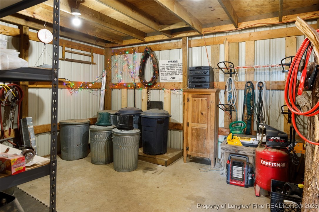 2574 Norrington Road Lillington, NC 27546 - Photo 42 of 50 a view of a storage room with water heater and racks