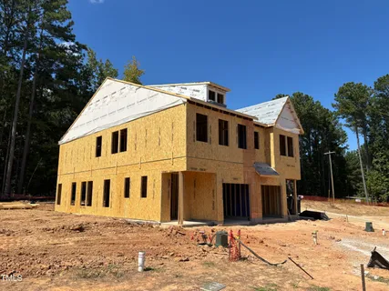 a view of a white house with a snow in the yard