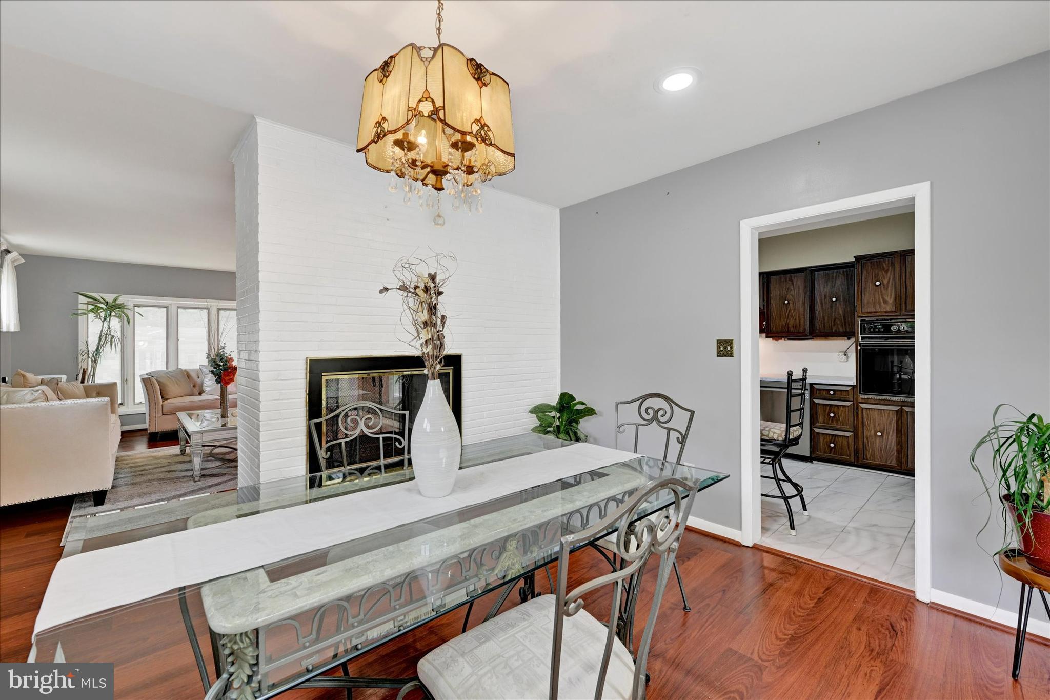6708 Selkirk Road Baltimore, MD 21239 - Photo 12 of 30 a view of a dining room with furniture a chandelier and wooden floor