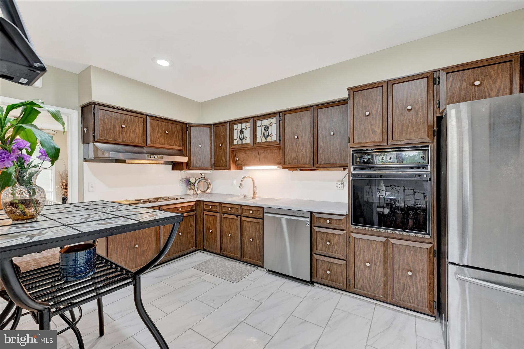 6708 Selkirk Road Baltimore, MD 21239 - Photo 14 of 30 a kitchen with stainless steel appliances granite countertop a refrigerator sink and cabinets