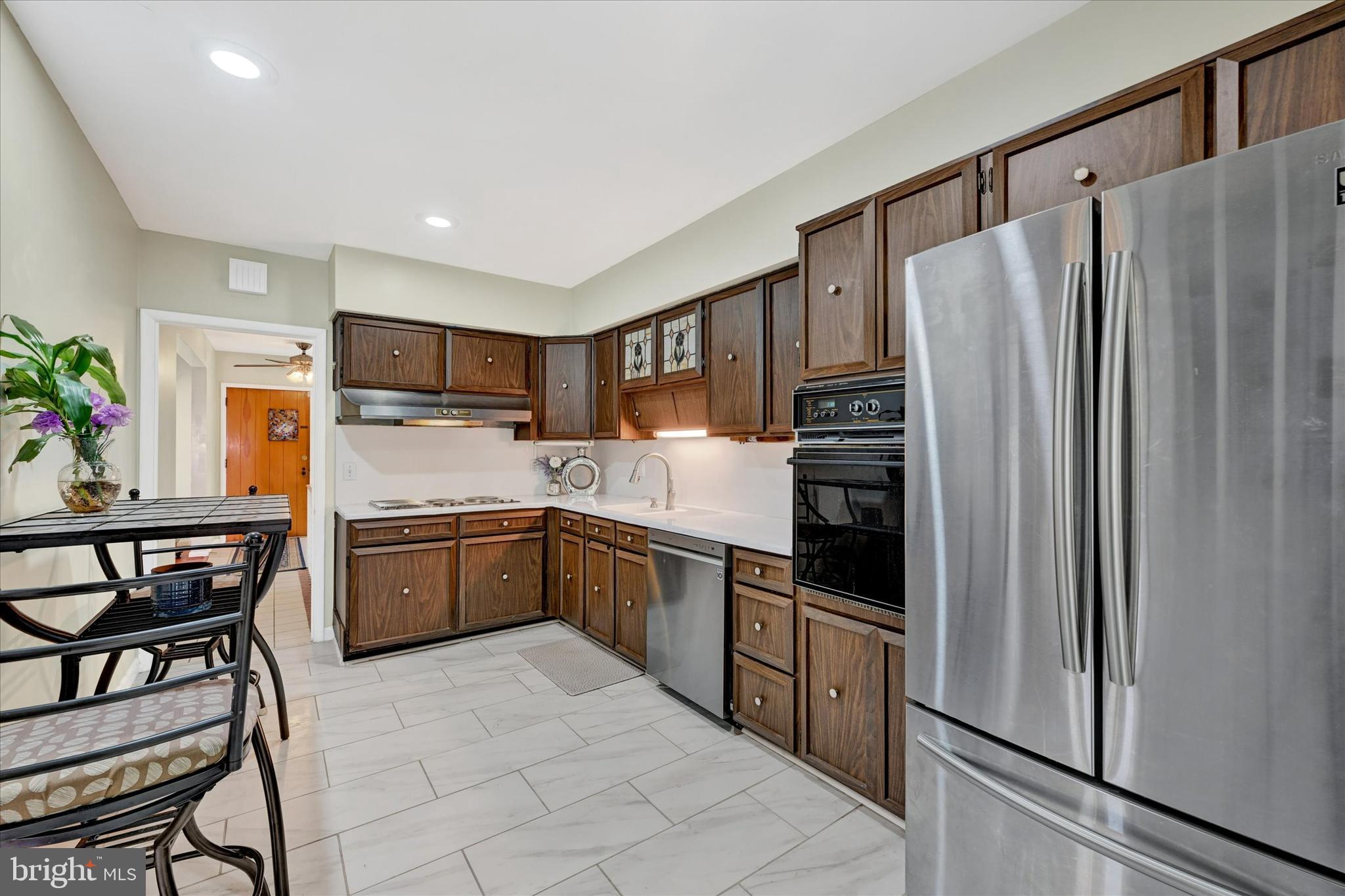 6708 Selkirk Road Baltimore, MD 21239 - Photo 15 of 30 a kitchen with stainless steel appliances granite countertop a refrigerator and a stove top oven