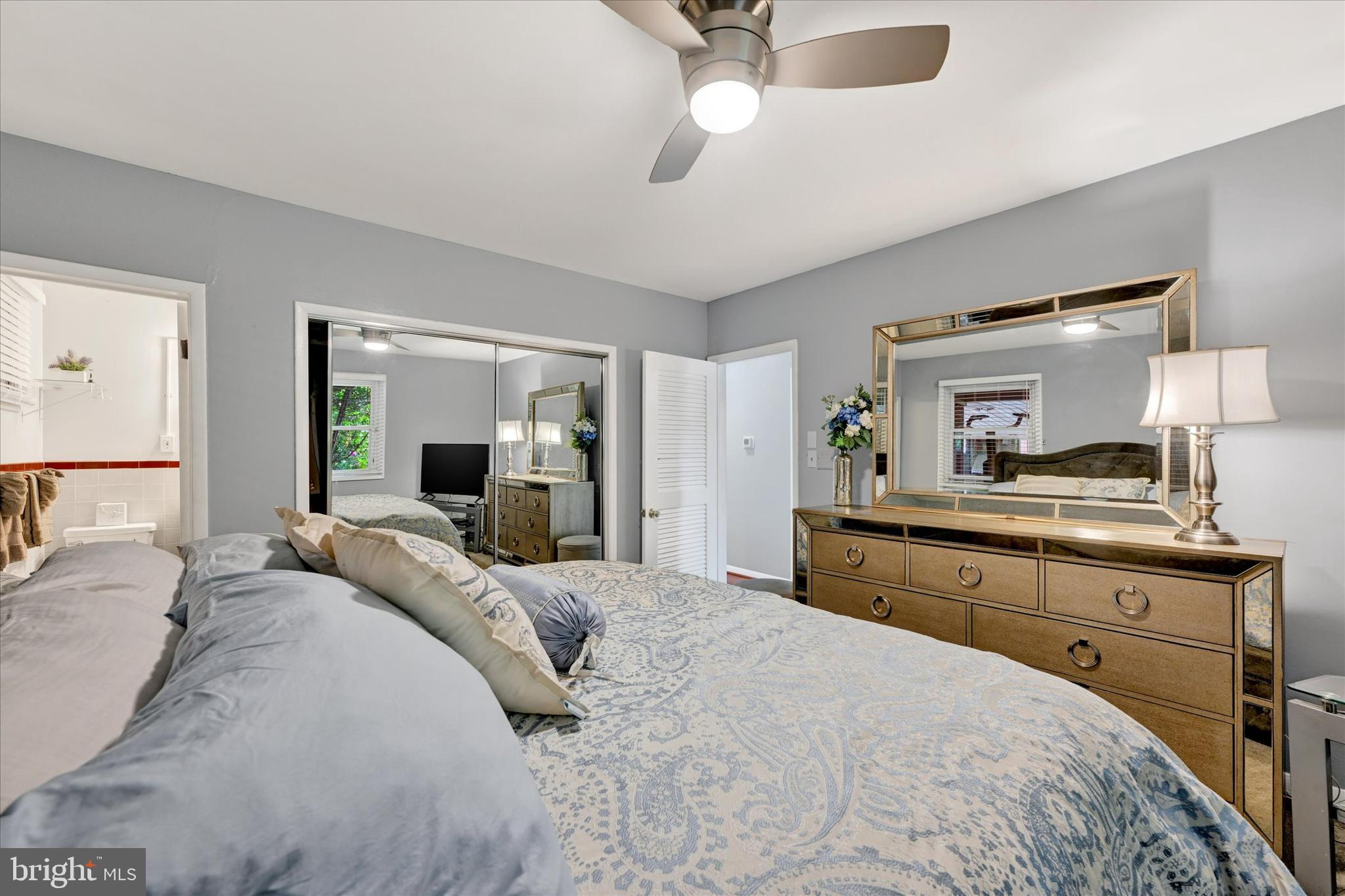 6708 Selkirk Road Baltimore, MD 21239 - Photo 20 of 30 a bedroom with a large bed and a flat tv screen on dresser