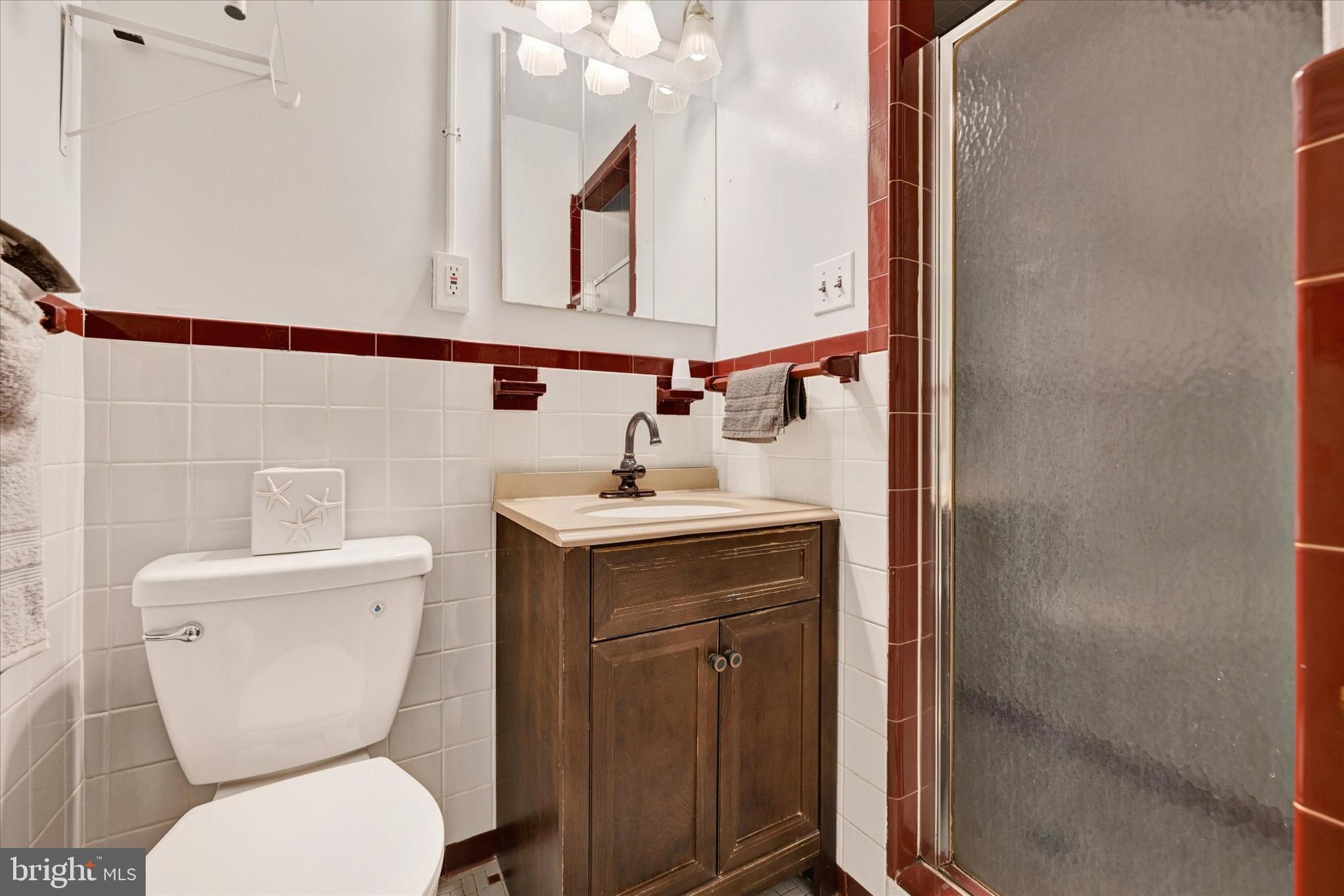 6708 Selkirk Road Baltimore, MD 21239 - Photo 21 of 30 a bathroom with a toilet a sink and mirror