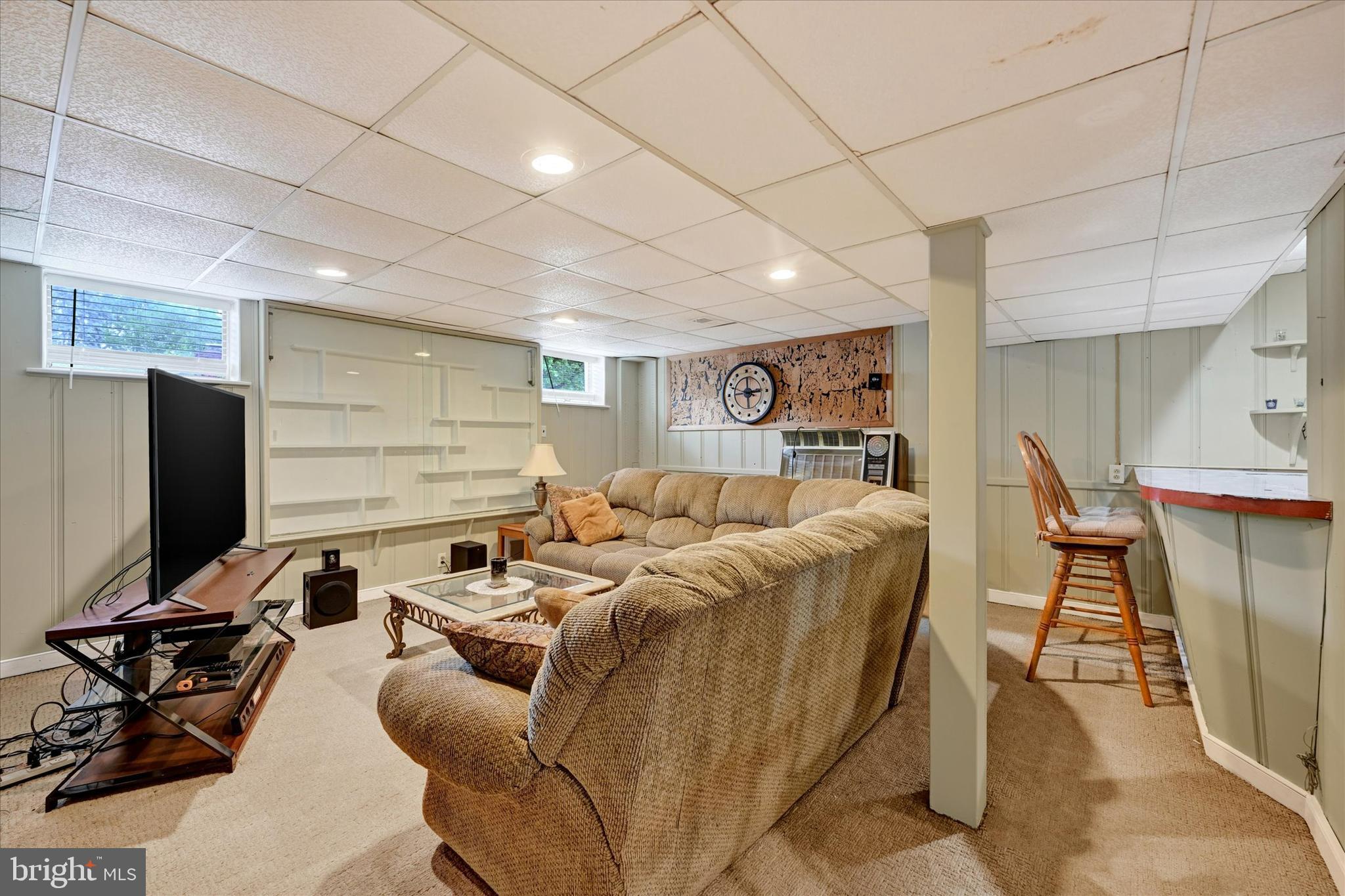 6708 Selkirk Road Baltimore, MD 21239 - Photo 22 of 30 a living room with furniture a wooden floor and a flat screen tv