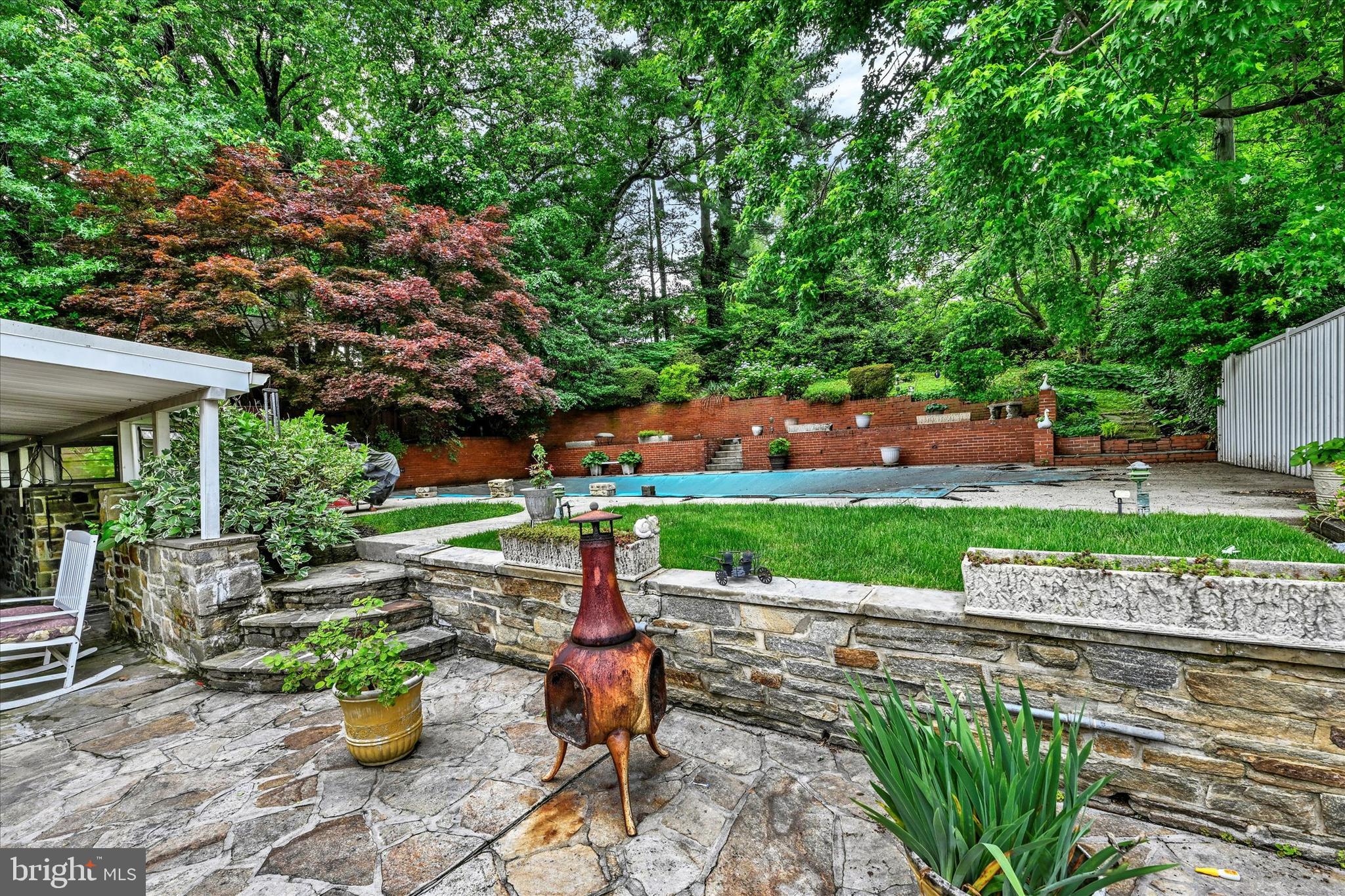 6708 Selkirk Road Baltimore, MD 21239 - Photo 27 of 30 a view of a patio with table and chairs potted plants and large tree