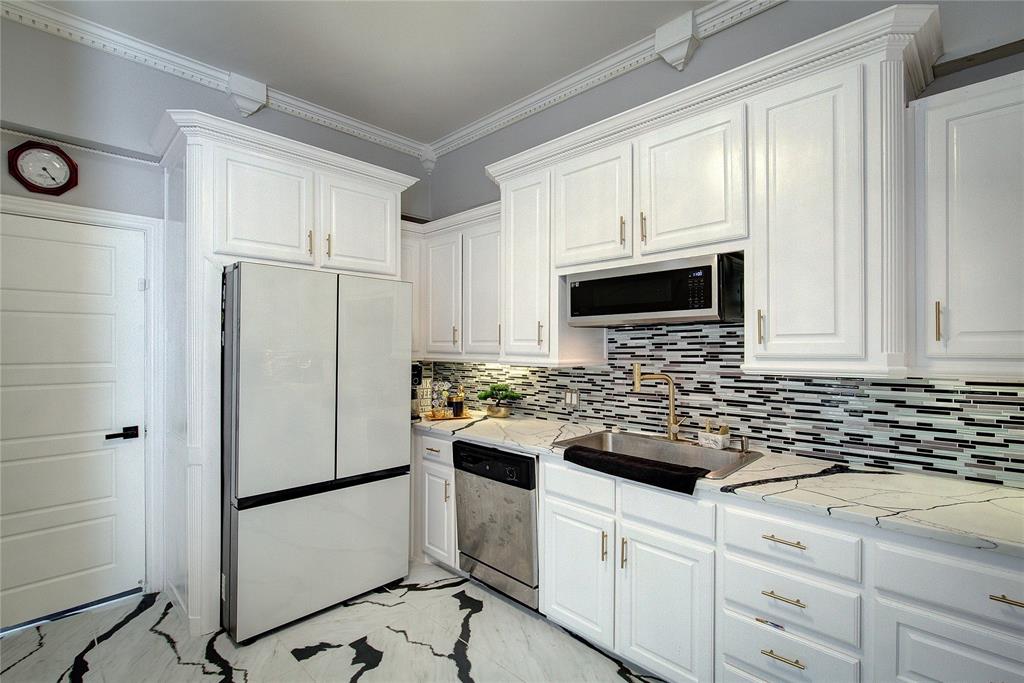 504 Summit Circle Heath, TX 75032 - Photo 13 of 39 a kitchen with white cabinets and white appliances