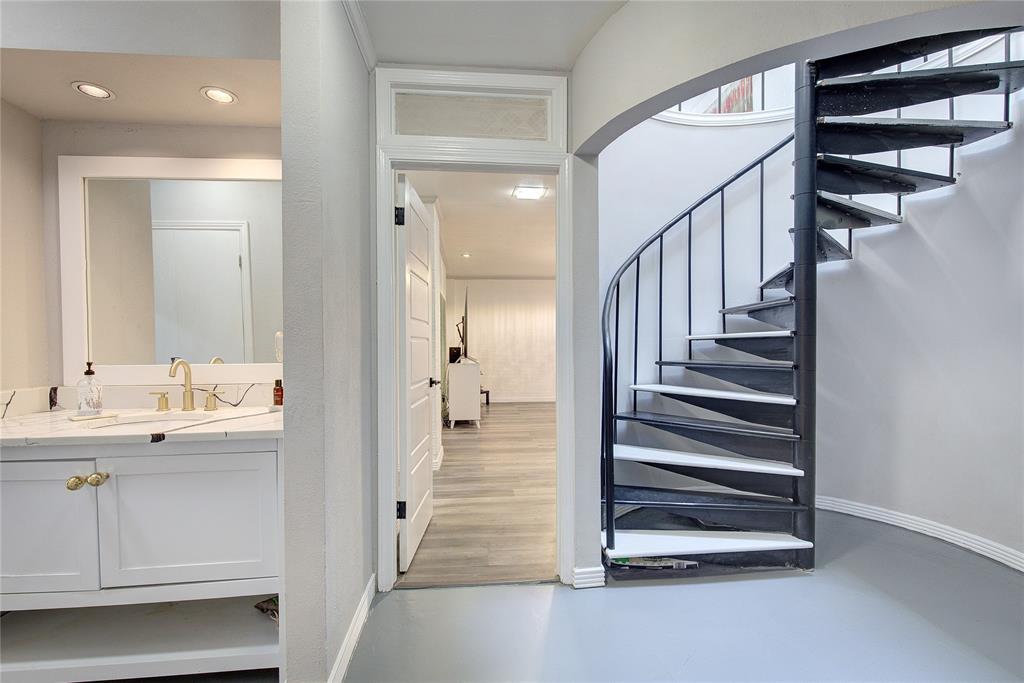504 Summit Circle Heath, TX 75032 - Photo 23 of 39 a view of a hallway with a white cabinet and a mirror