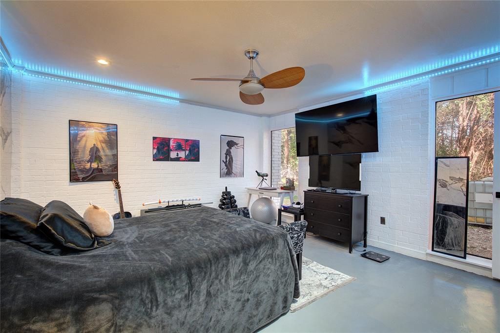 504 Summit Circle Heath, TX 75032 - Photo 24 of 39 a bedroom with a bed and a flat screen tv
