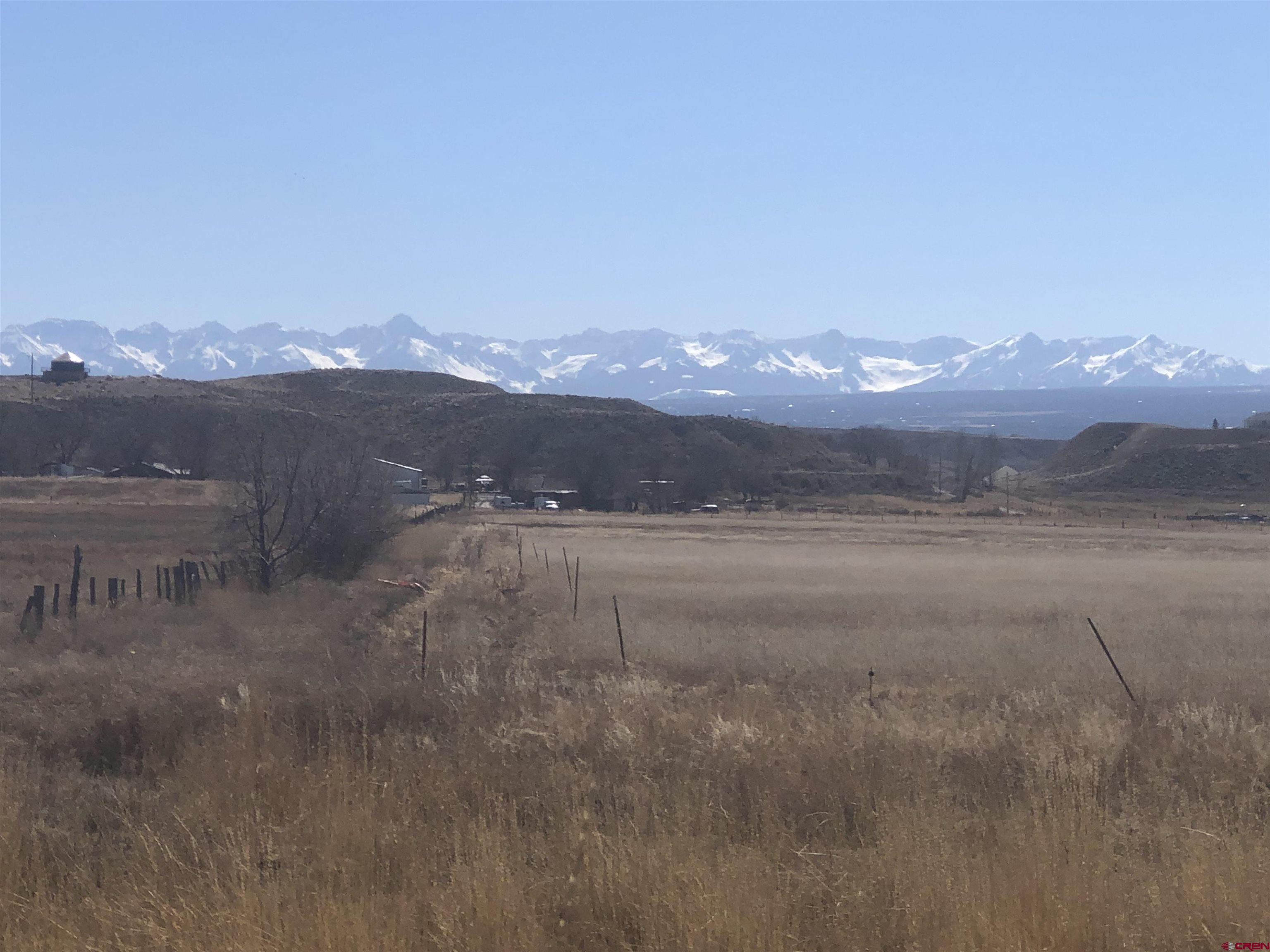 Tract 3 East Oak Grove Road Montrose, CO 81401 - Photo 5 of 18 a view of a lake with mountains in the background