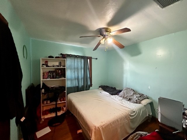 602 South 11th Street Fernandina Beach, FL 32034 - Photo 12 of 14 a bedroom with a bed and a book shelf