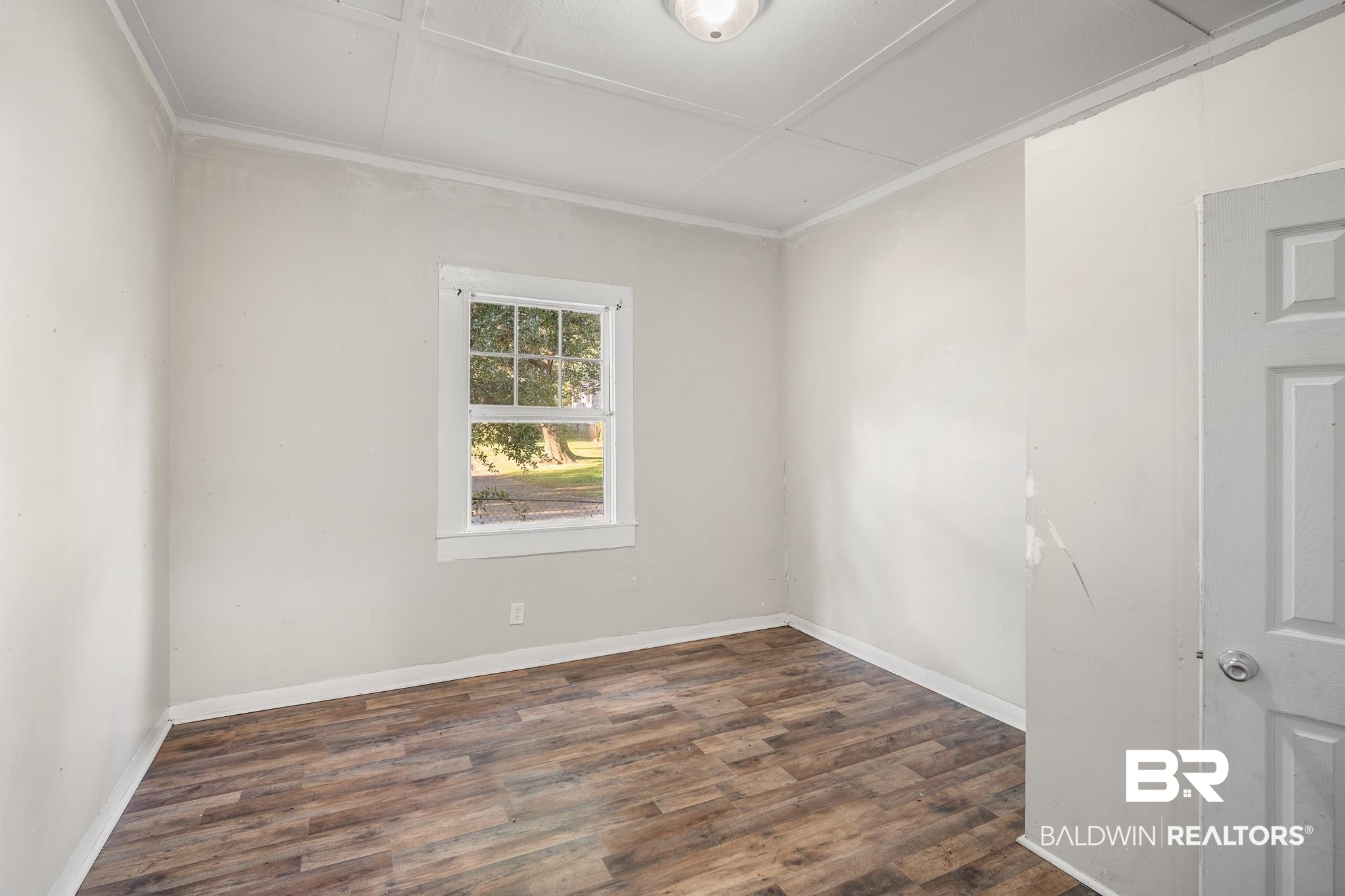 401 Gaston Street Mobile, AL 36603 - Photo 14 of 17 Empty room with crown molding and dark hardwood / wood-style flooring