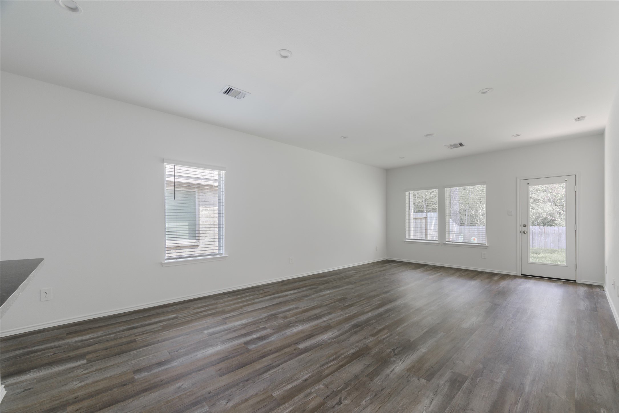 5619 Simcrest Grove Dr Spring Spring, TX 77373 - Photo 12 of 35 a view of an empty room with wooden floor and a window