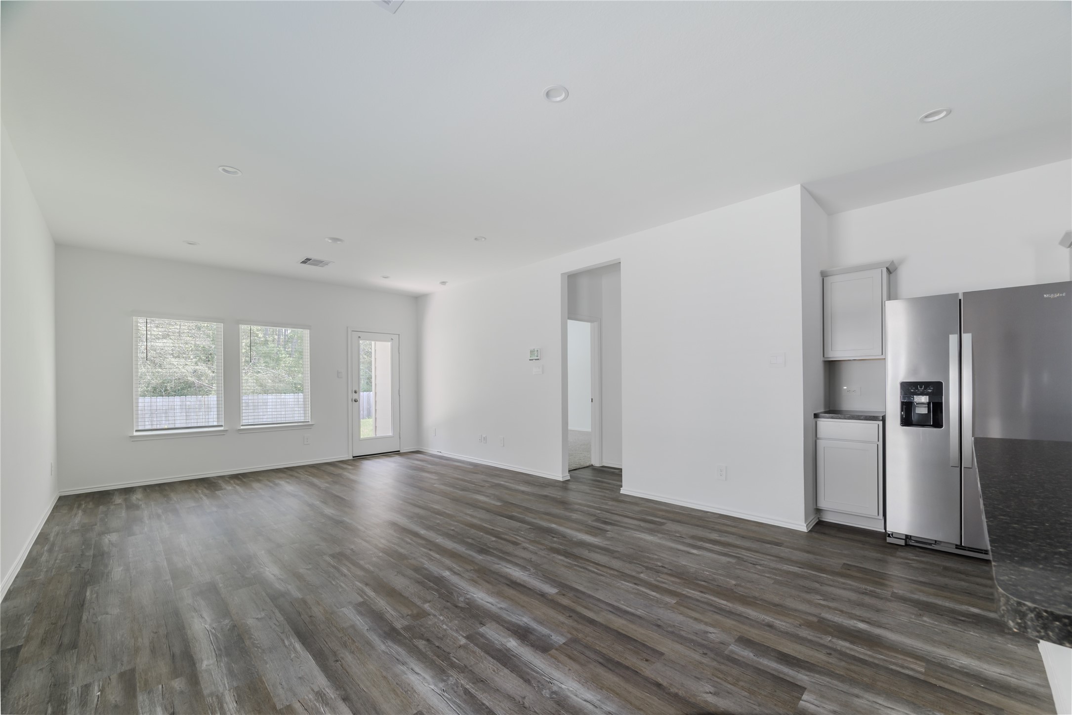 5619 Simcrest Grove Dr Spring Spring, TX 77373 - Photo 13 of 35 a view of an empty room with a window and wooden floor
