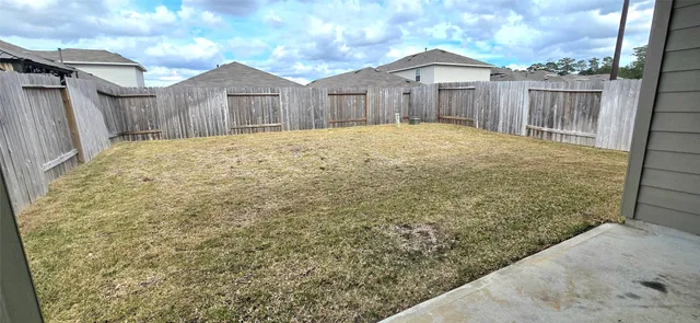 a large house with a wooden fence