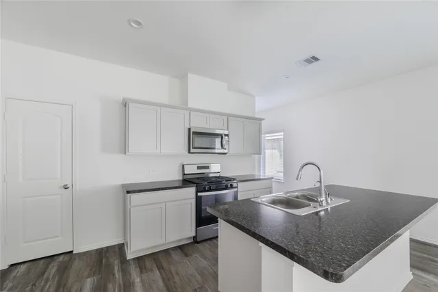 a kitchen with a sink and cabinets