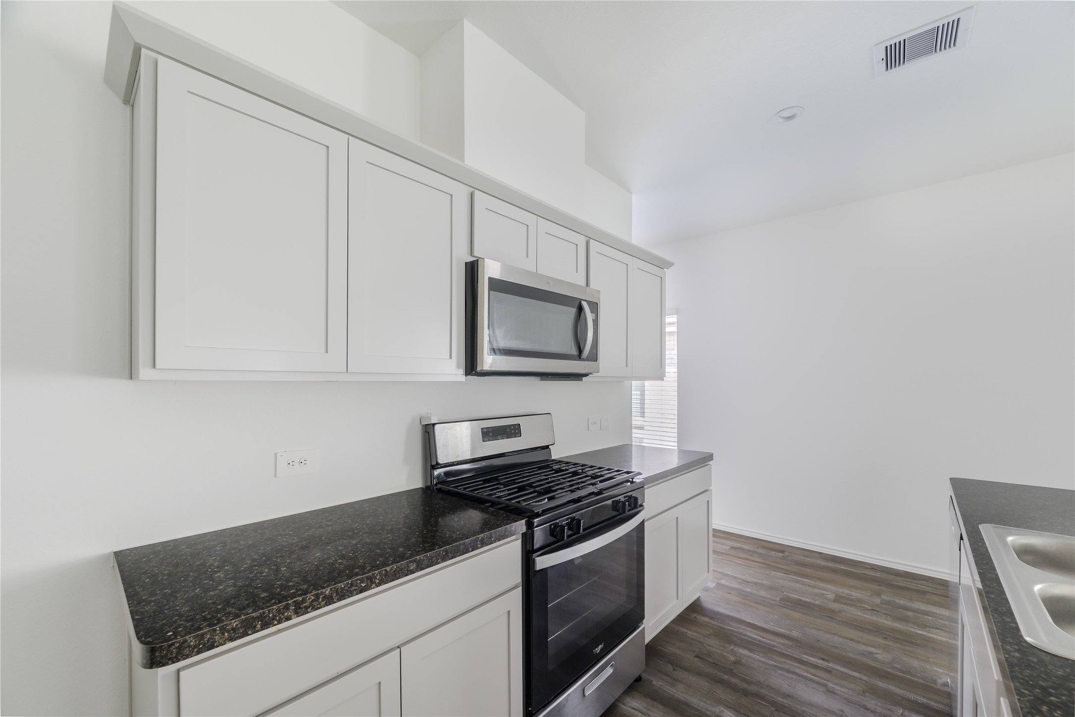 5619 Simcrest Grove Dr Spring Spring, TX 77373 - Photo 9 of 35 a kitchen with granite countertop a stove and a sink