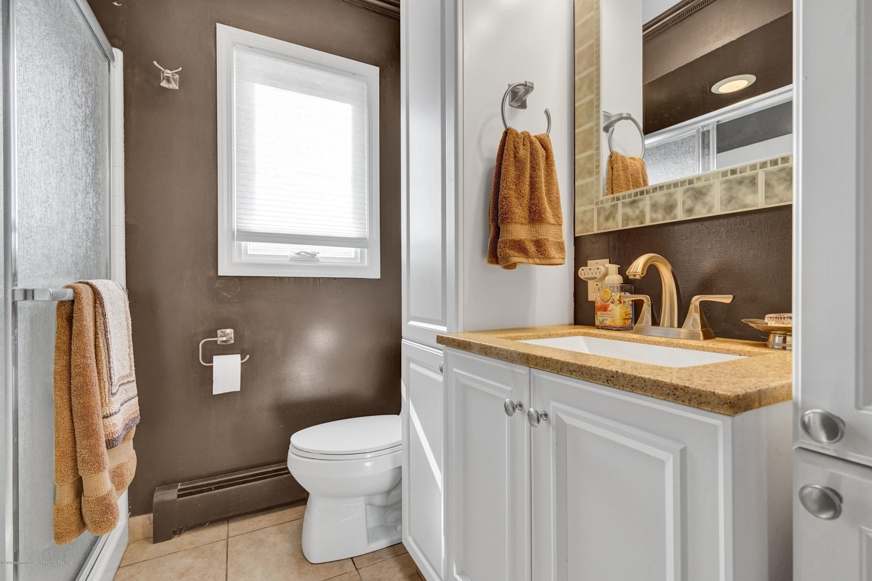 25 Harbor Road Morganville, NJ 07751 - Photo 20 of 39 a bathroom with a toilet sink and mirror