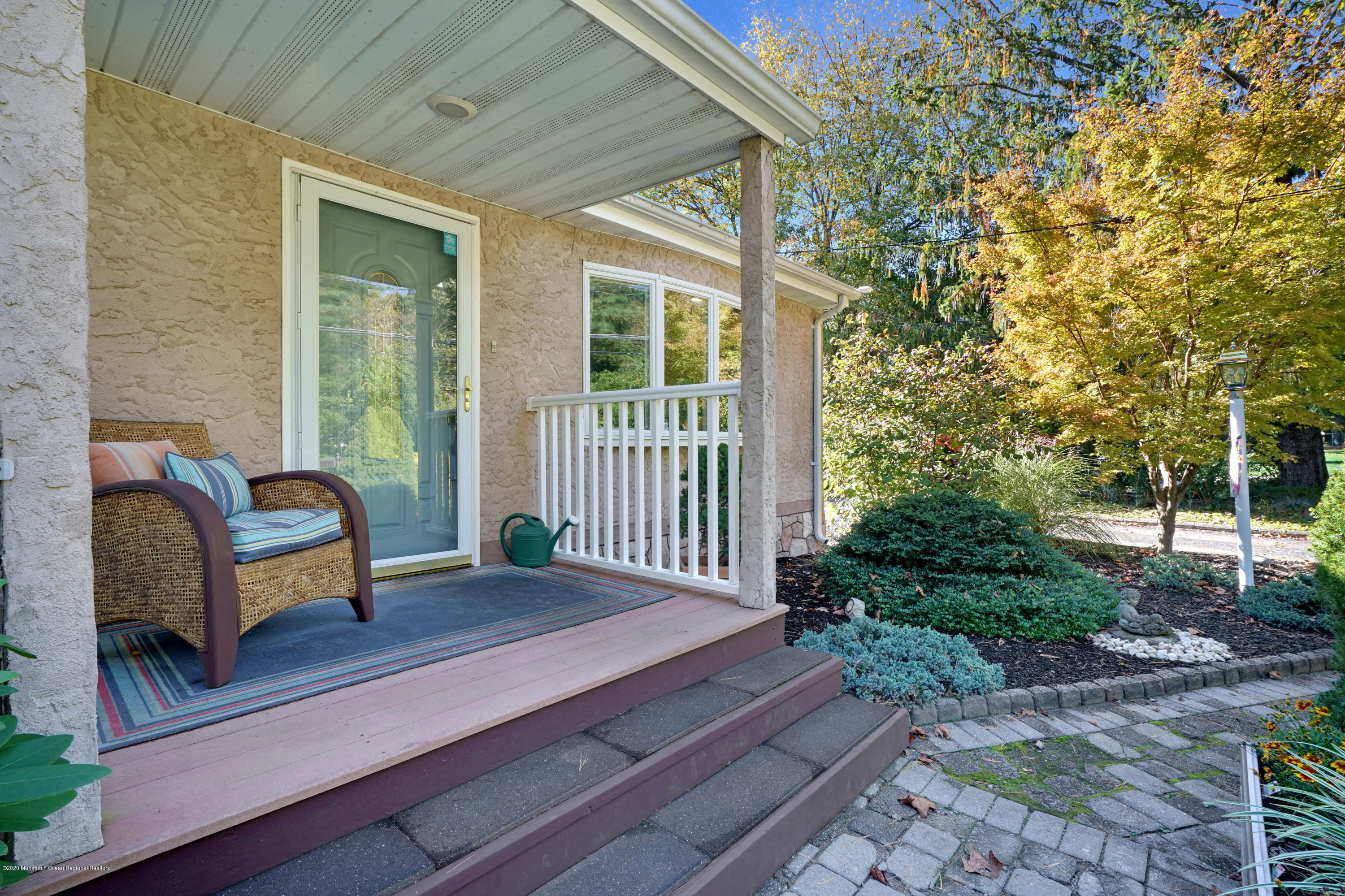 25 Harbor Road Morganville, NJ 07751 - Photo 4 of 39 a bench sitting in front of a house