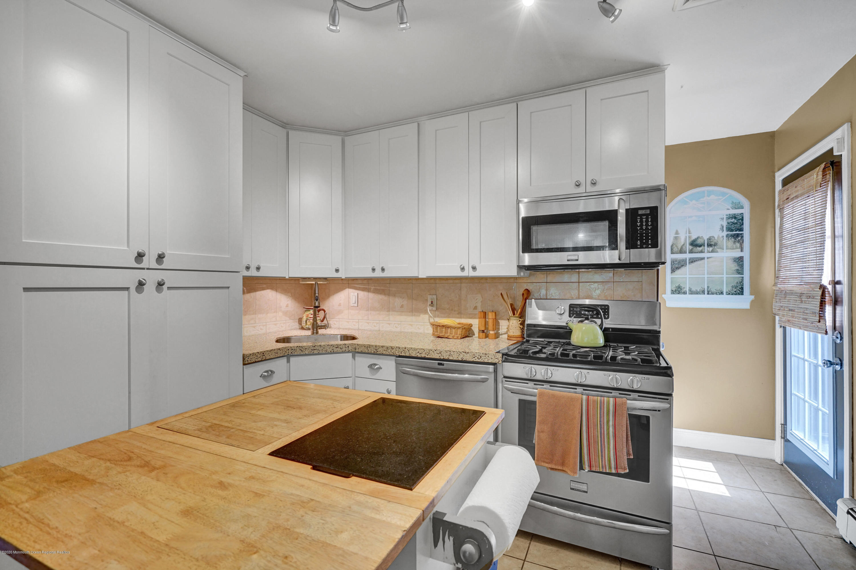 25 Harbor Road Morganville, NJ 07751 - Photo 6 of 39 a kitchen with a sink a stove and cabinets