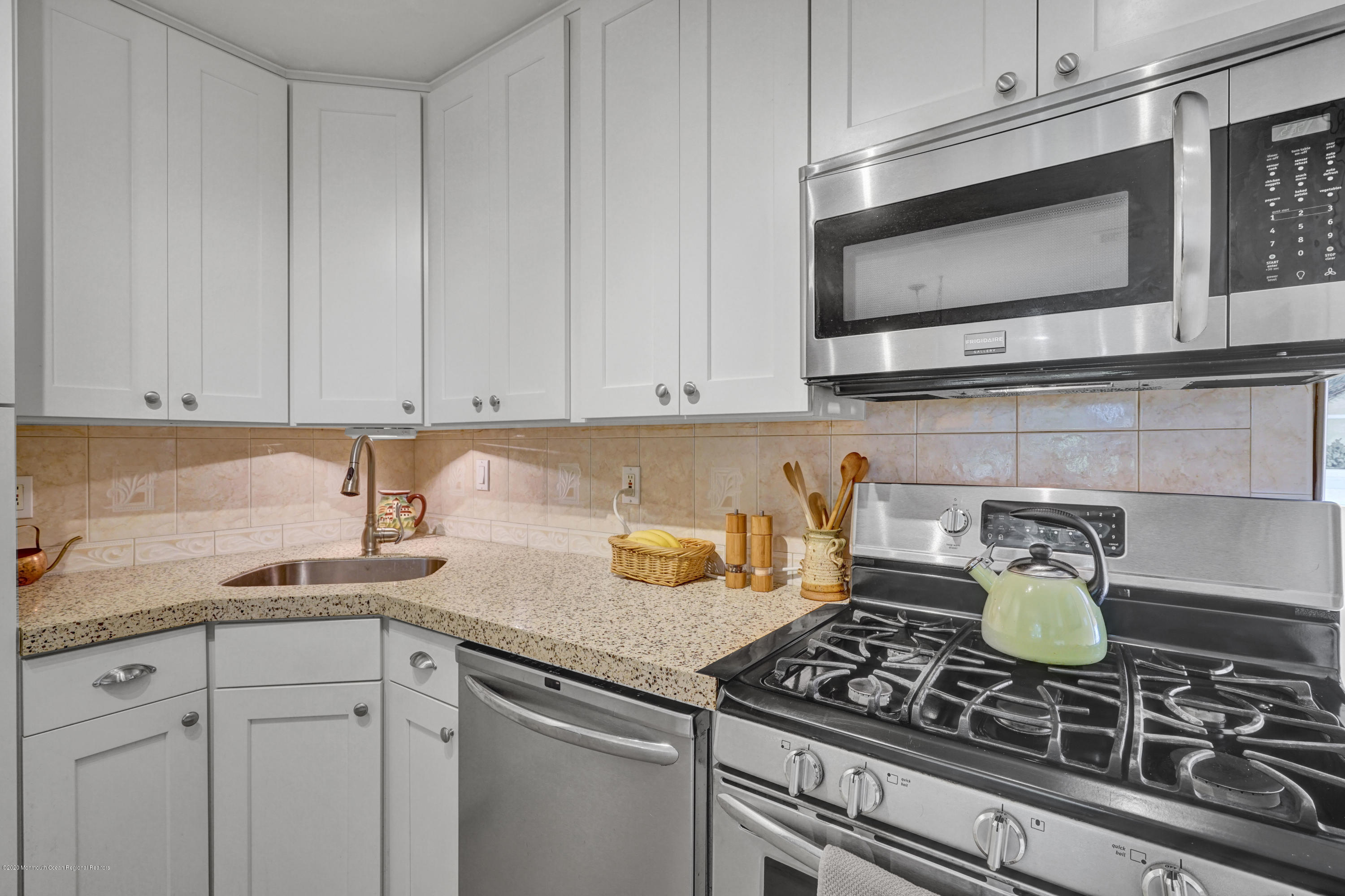 25 Harbor Road Morganville, NJ 07751 - Photo 8 of 39 a kitchen with a stove and a microwave