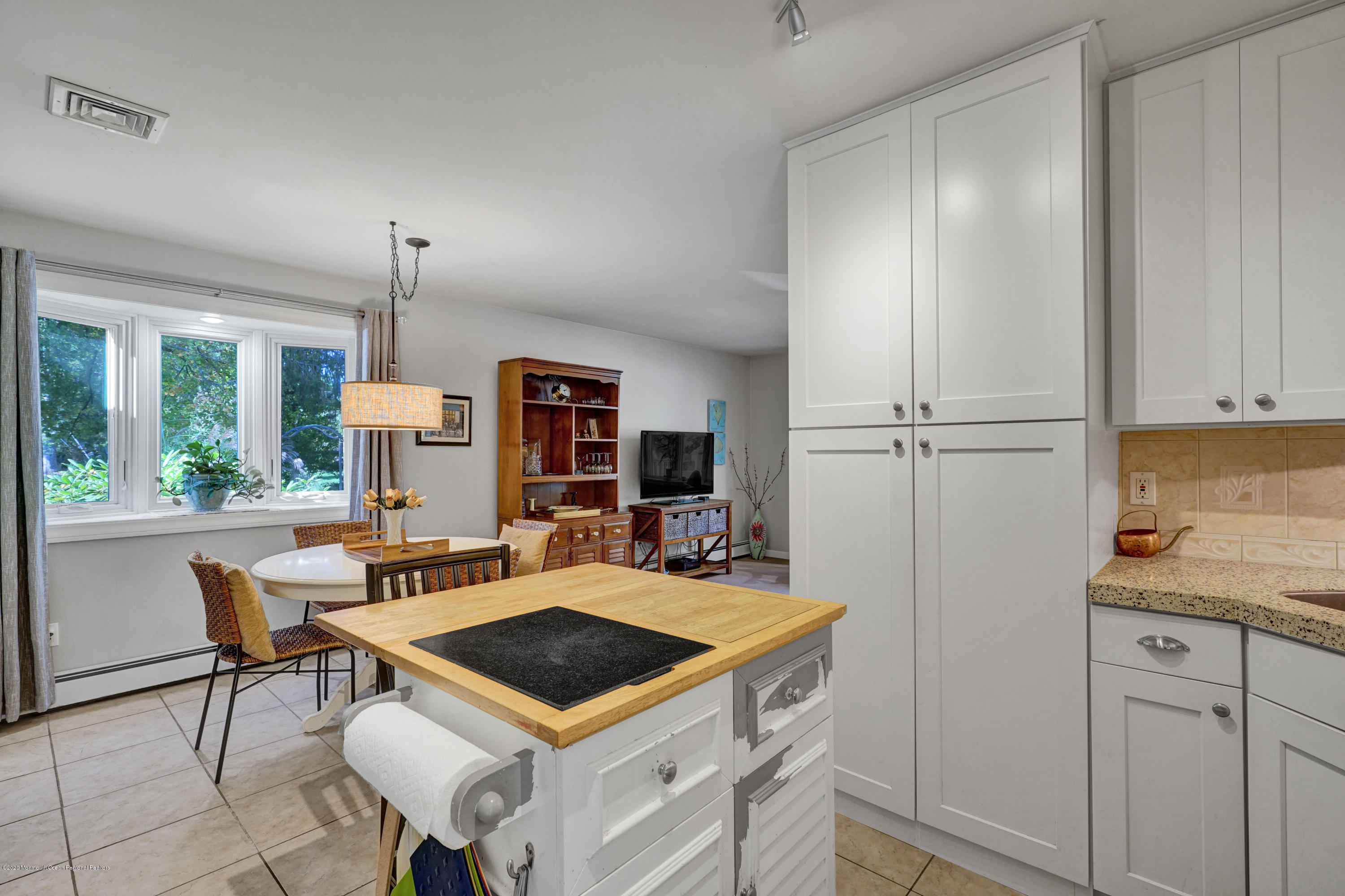 25 Harbor Road Morganville, NJ 07751 - Photo 9 of 39 a view of a kitchen with a table and chairs