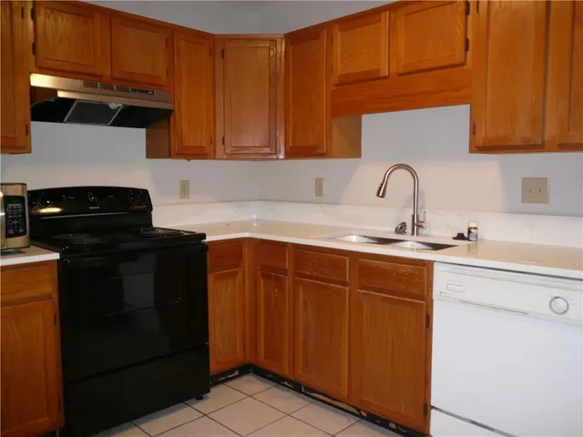 a kitchen with stainless steel appliances granite countertop a sink stove and cabinets
