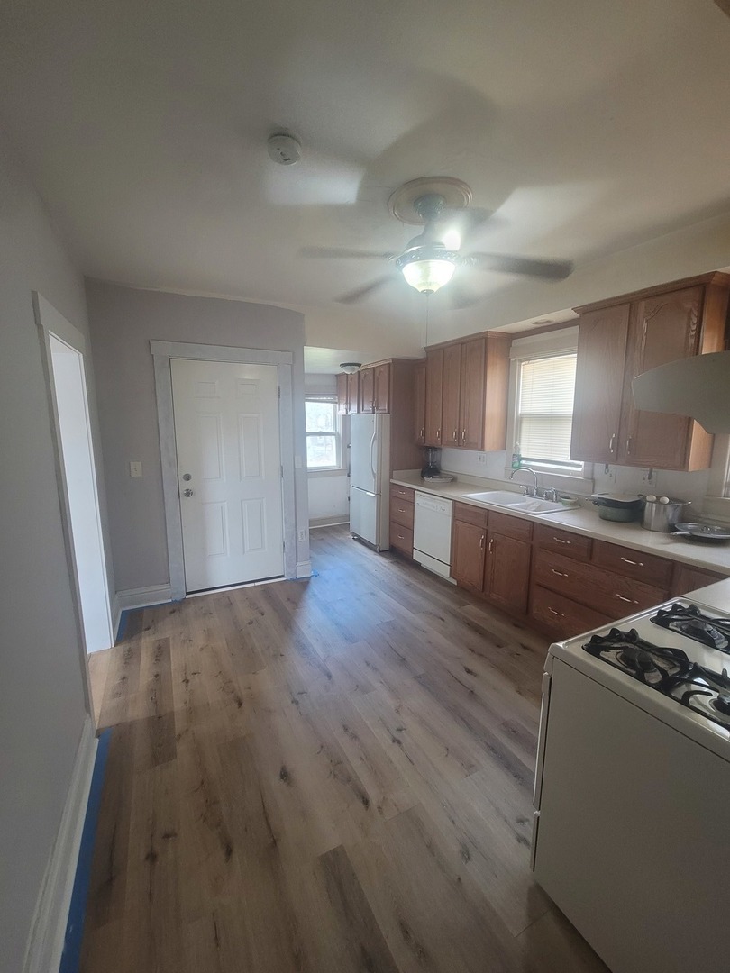 526 North View Street Aurora, IL 60506 - Photo 4 of 5 a kitchen with stainless steel appliances granite countertop a stove a sink dishwasher and a refrigerator with wooden floor