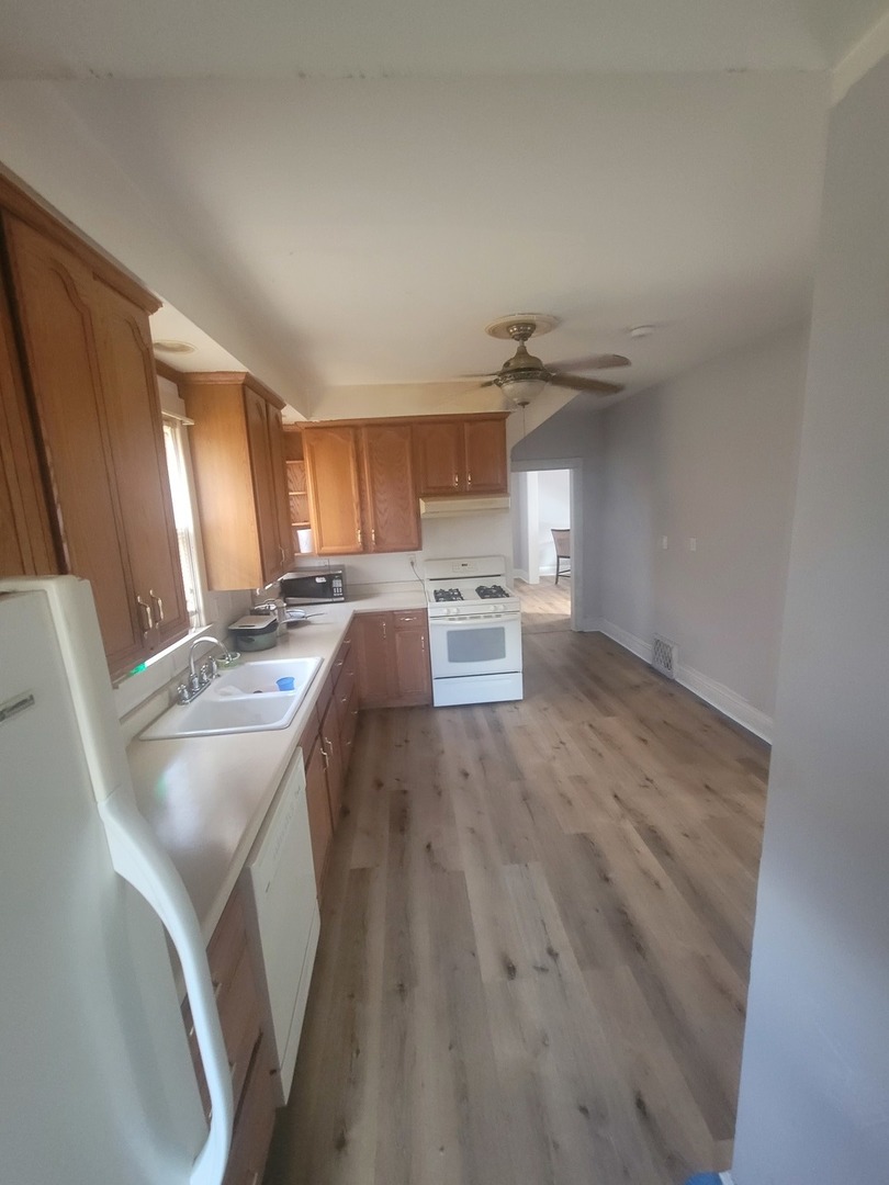 526 North View Street Aurora, IL 60506 - Photo 5 of 5 a kitchen with kitchen island wooden floors and stainless steel appliances