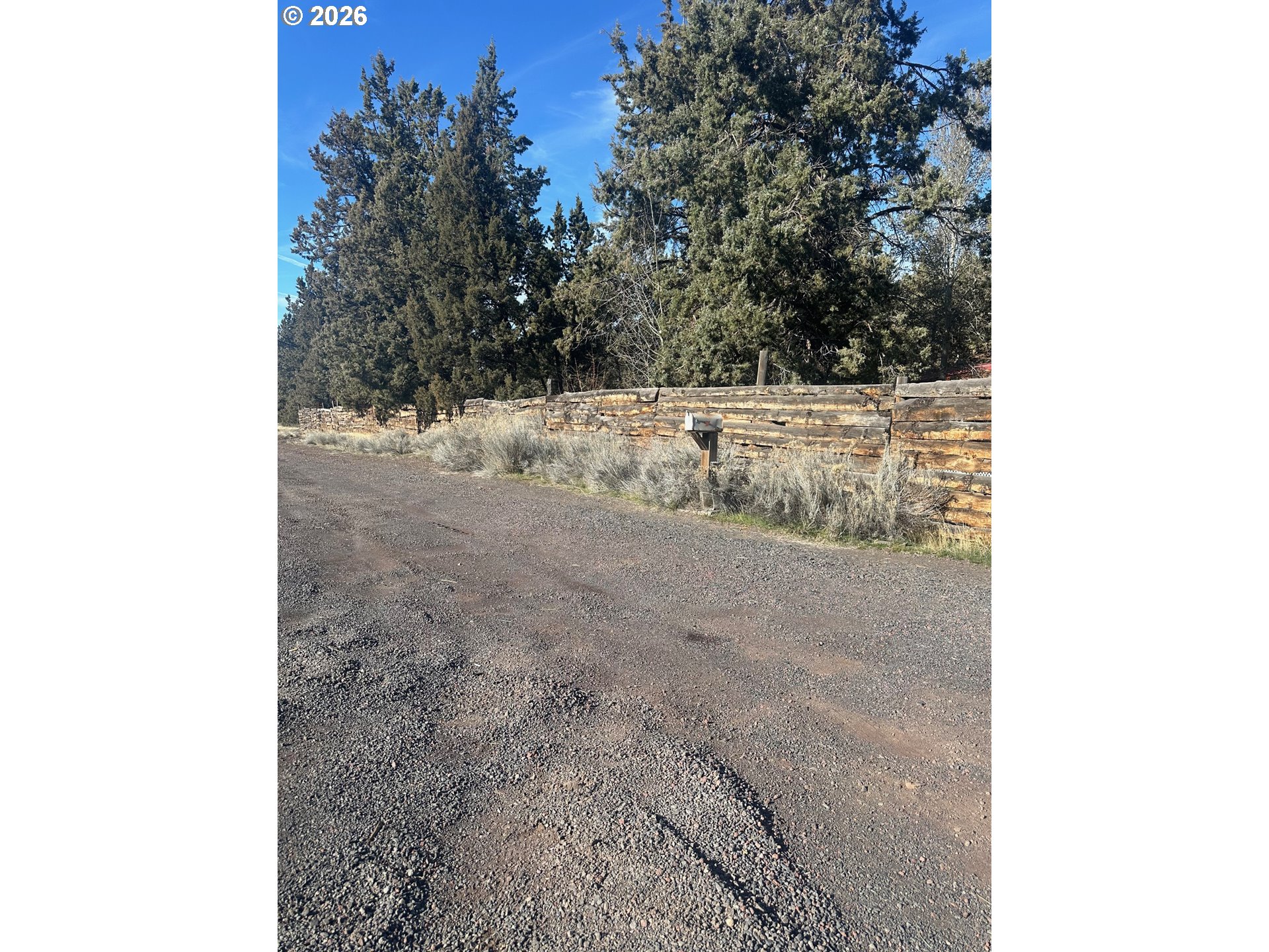 6792 Southeast Juniper Canyon Road Prineville, OR 97754 - Photo 29 of 44 a view of a dry yard with trees