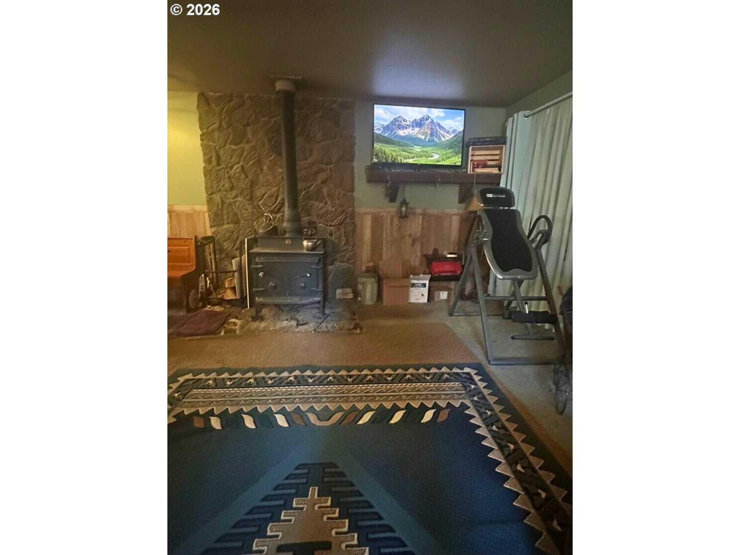 6792 Southeast Juniper Canyon Road Prineville, OR 97754 - Photo 3 of 44 a view of living room with a table and a fireplace