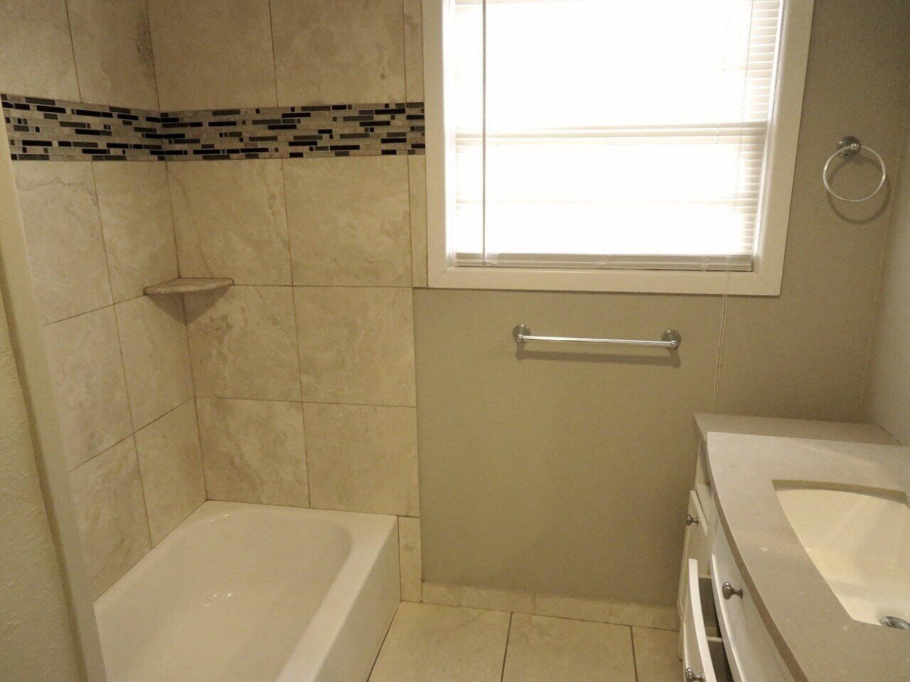 3211 33rd Street Lubbock, TX 79410 - Photo 6 of 7 a bathroom with a shower a toilet and a window