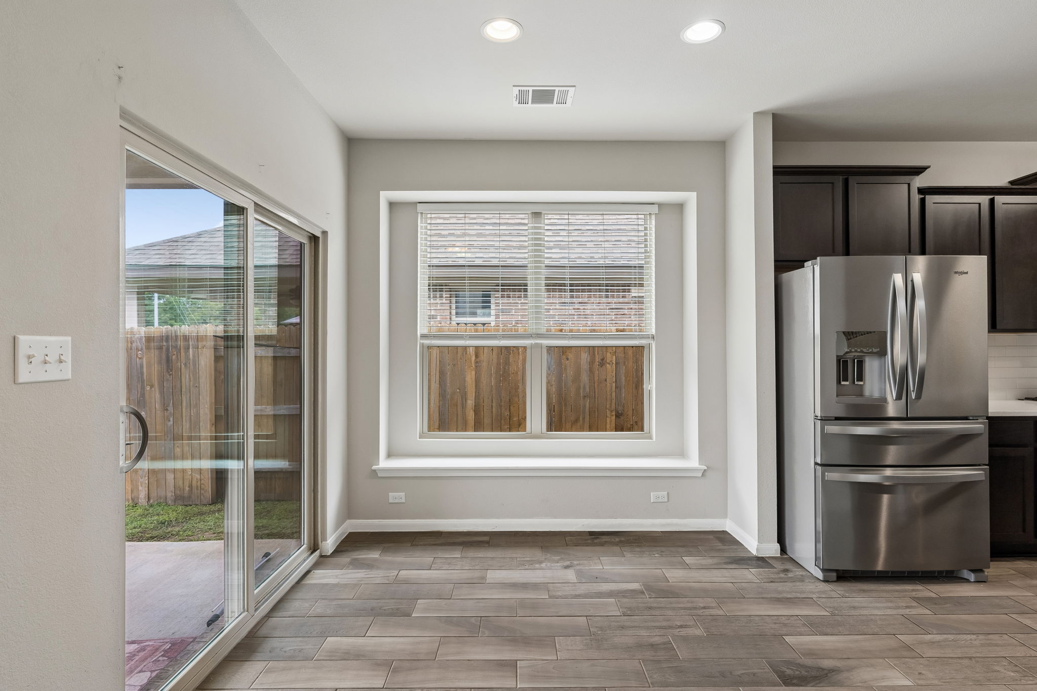 301 Rimrock Court Bastrop, TX 78602 - Photo 8 of 21 A sunlit kitchen space features durable tile flooring and access to the outdoors.