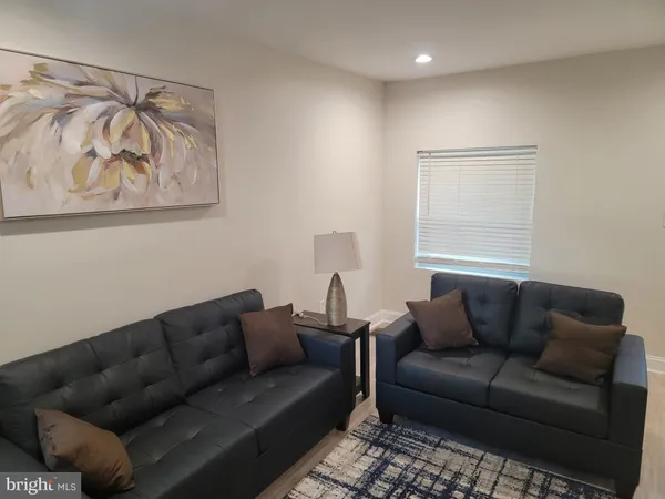 a living room with furniture and a rug