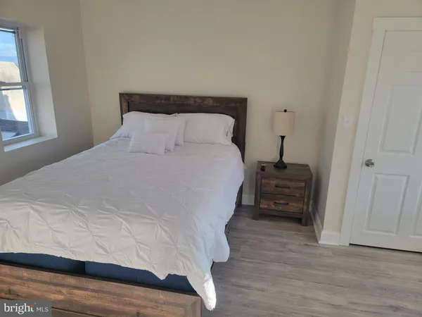 a large white bed in a white room