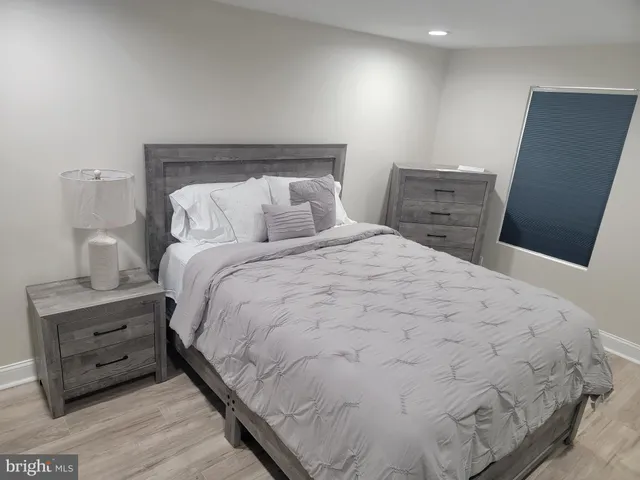 a bedroom with a bed and mirror