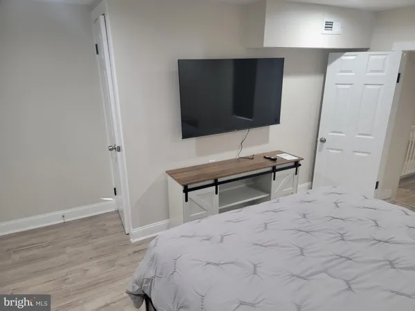a bedroom with a bed and a flat screen tv