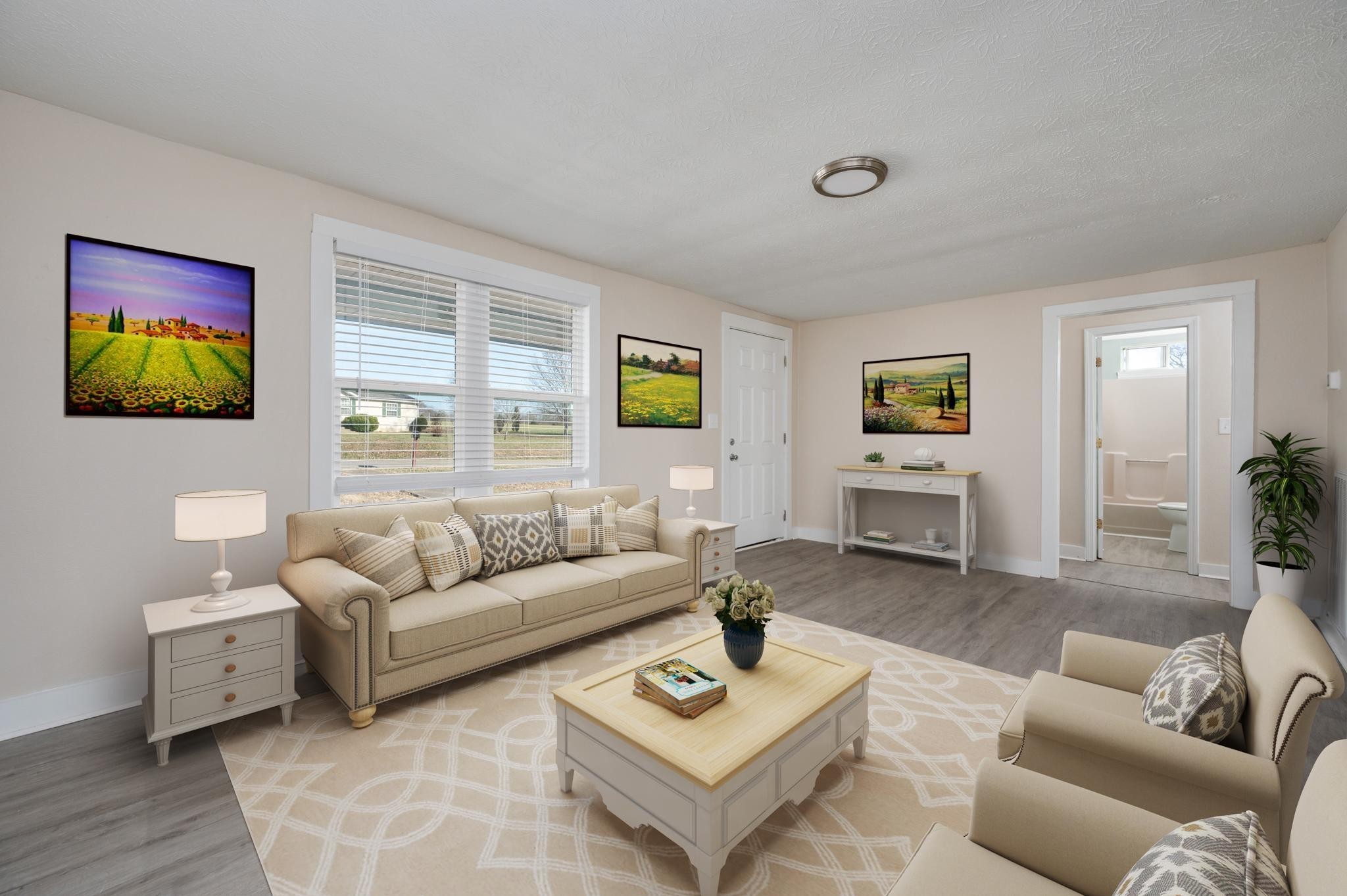 a living room with furniture and a wooden floor