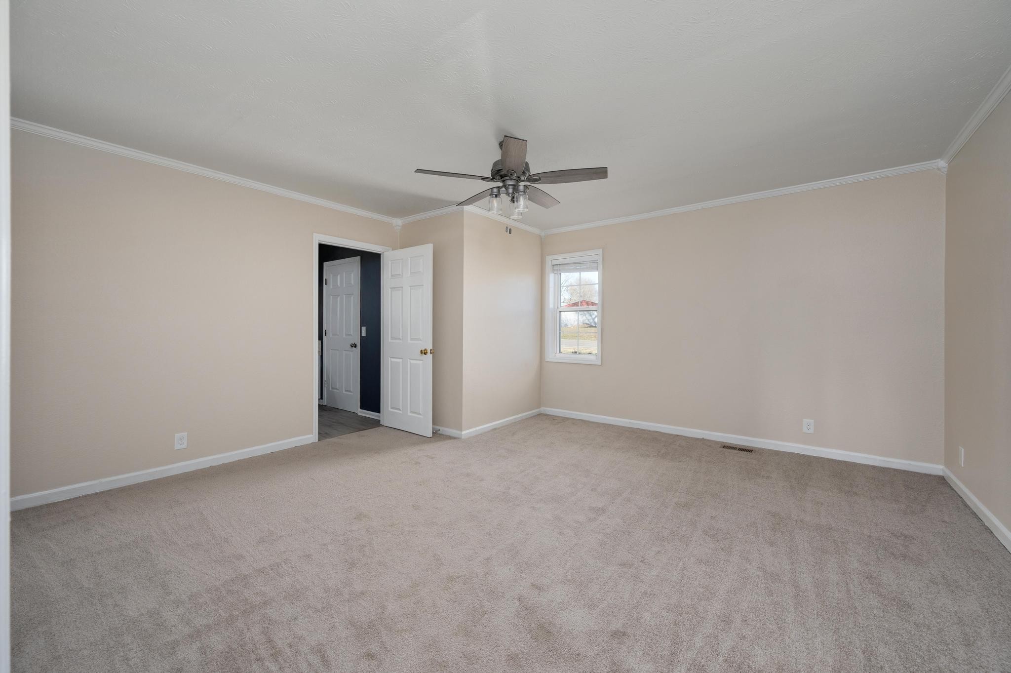 621 Halltown Road Portland, TN 37148 - Photo 12 of 23 an empty room with a ceiling fan and a window