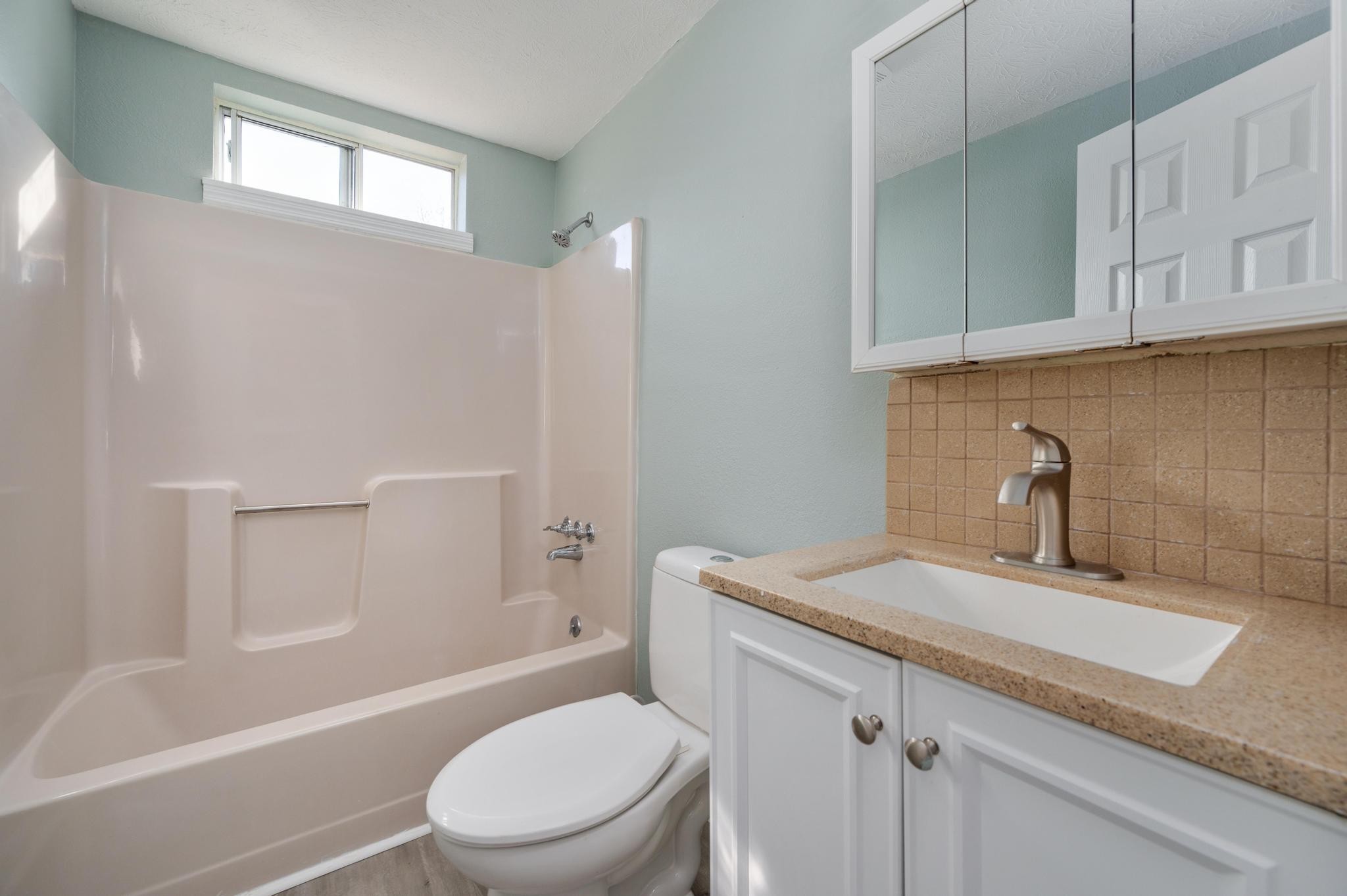 621 Halltown Road Portland, TN 37148 - Photo 13 of 23 a bathroom with a granite countertop sink toilet and shower